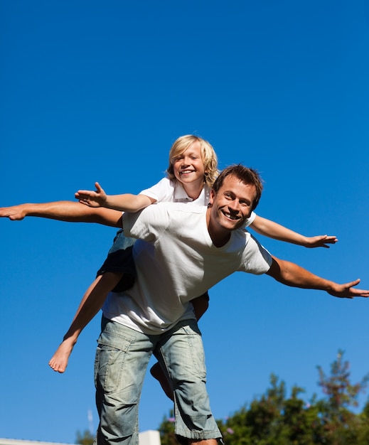 Attractive father with his son on his back outdoor