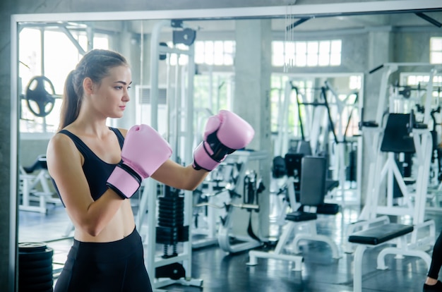 Attractive Female Boxer At Training in gym 