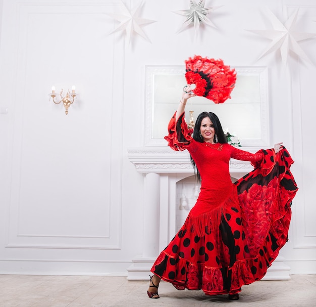 Foto attraente ballerina in abito rosso che esegue danza