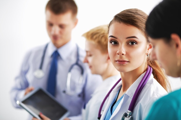 Attractive female doctor in front of medical group