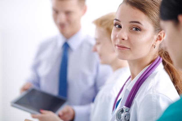 Attractive female doctor in front of medical group