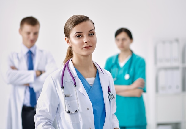 Attractive female doctor in front of medical group