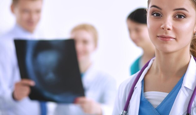 Attractive female doctor in front of medical group