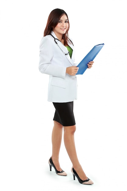 Attractive female doctor in lab coat holding clipboard