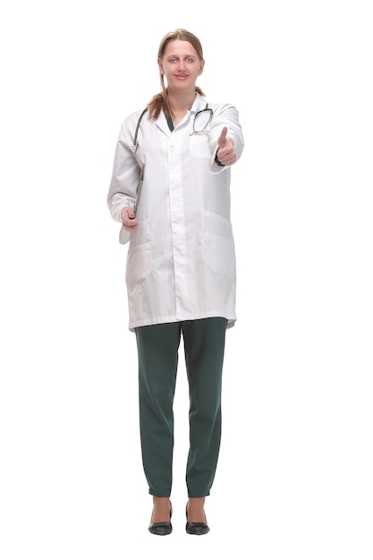 Attractive female doctor standing on white background holding clipboard and doing paperwork