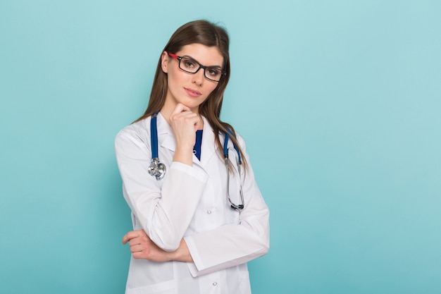 Attractive female doctor in white coat and glasses