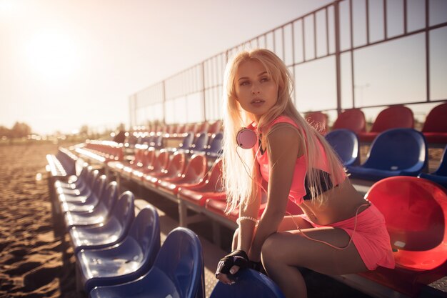 Attractive female runner seated on the beach resting