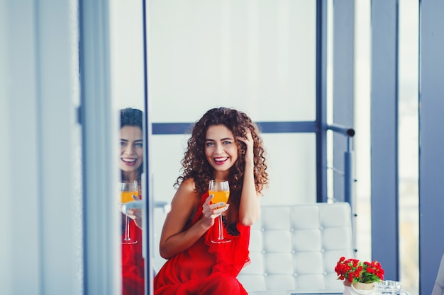 Attractive funny young woman sitting on sofa