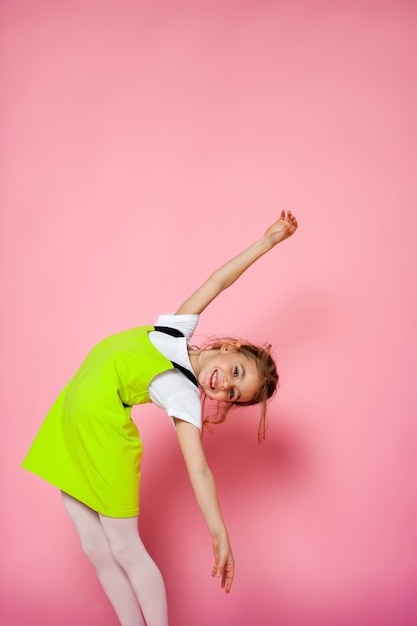 Attractive girl having fun on the pink background