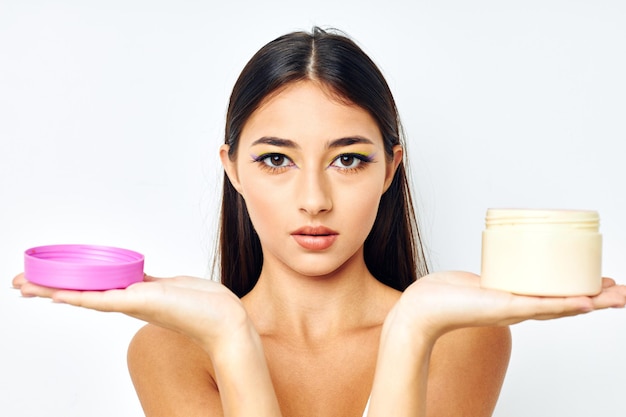 Attractive girl posing cream jar cosmetics isolated background unaltered