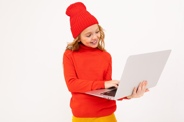 Attractive girl in a red hat writes a message on a notebook