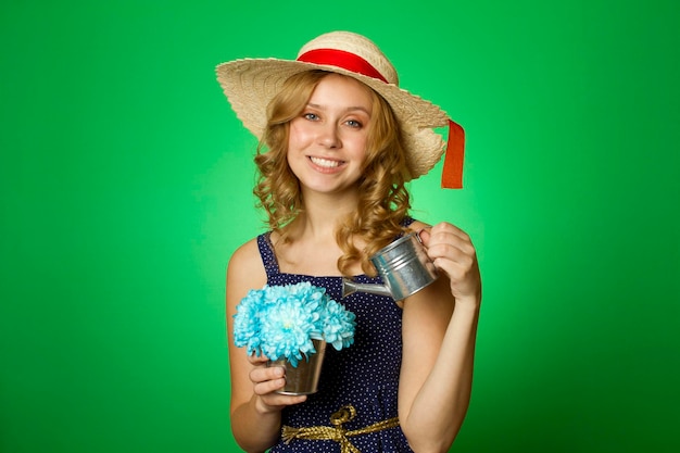 Attractive girl watering flowers