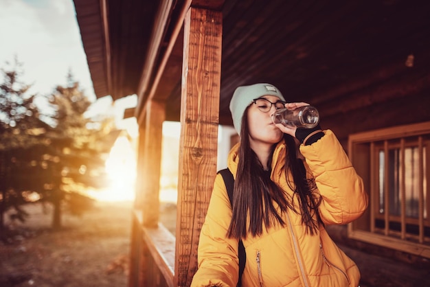 attractive girl who hikers resting in a wooden cottage