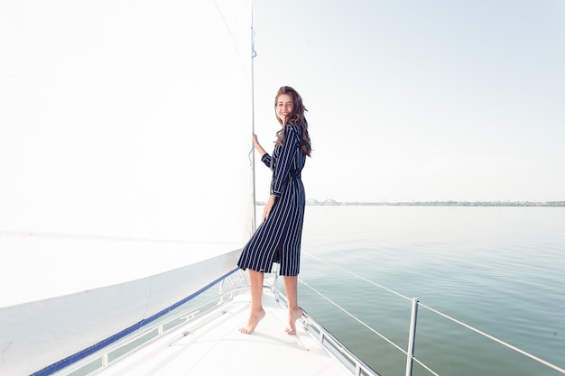 Attractive girl on a yacht at summer day