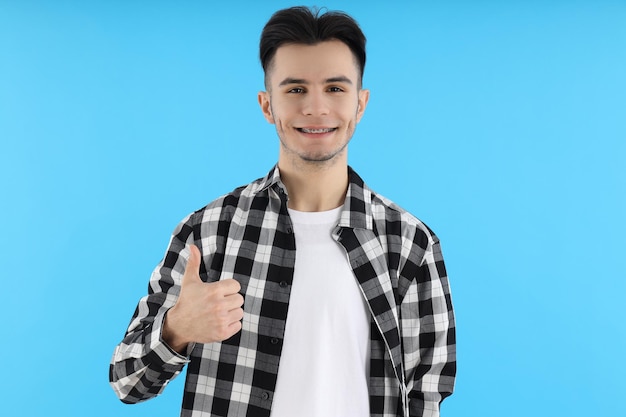 Attractive guy in shirt on blue background