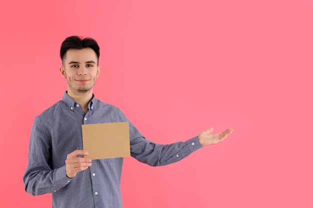 Attractive guy with space for text on pink background