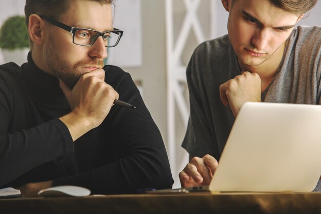 Attractive guys discussing project