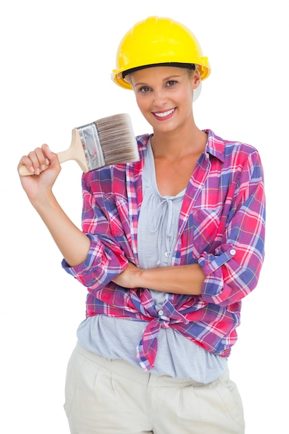 Attractive handy woman holding a brush and smiling at camera 