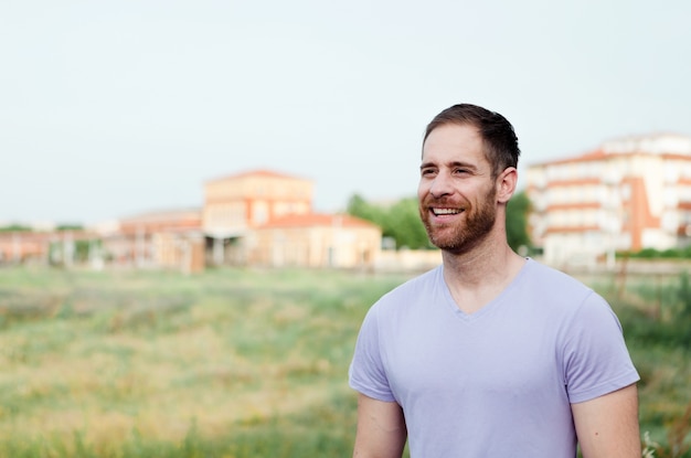 Attractive happy guy with beard and purple tshirt