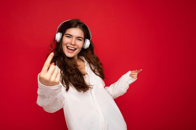 Attractive happy smiling young brunette female person wearing white shirt and optical glasses