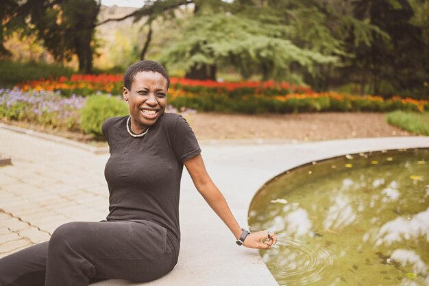 Attractive happy smiling young natural beauty short haired african woman wearing total black