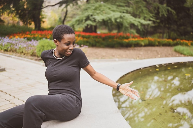 Attractive happy smiling young natural beauty short haired african woman wearing total black