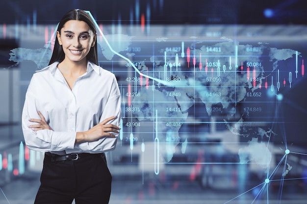 Attractive happy young european businesswoman with glowing candlestick forex chart and map hologram on blurry office interior background Stock investment market and money concept Double exposure