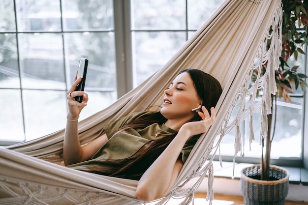 Attractive happy young woman relaxing at home