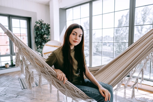 Attractive happy young woman relaxing at home