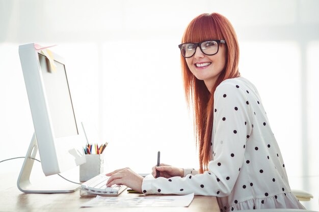 Attractive hipster woman using graphics tablet 