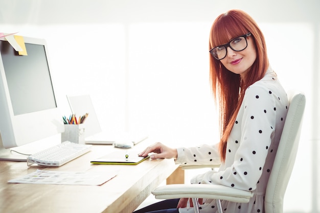 Attractive hipster woman using graphics tablet 