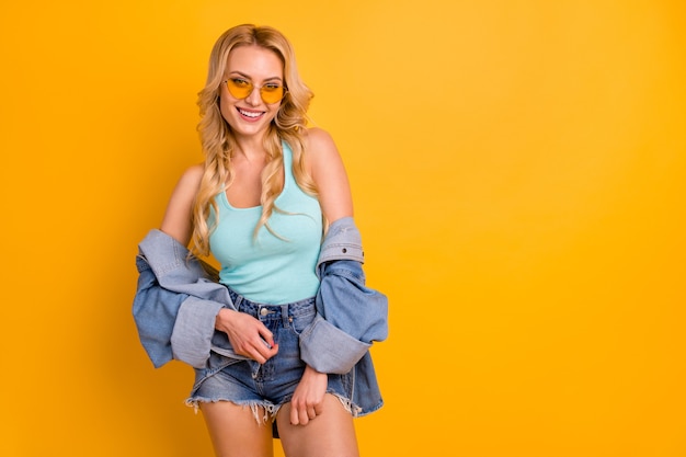 attractive lady good mood posing on yellow wall