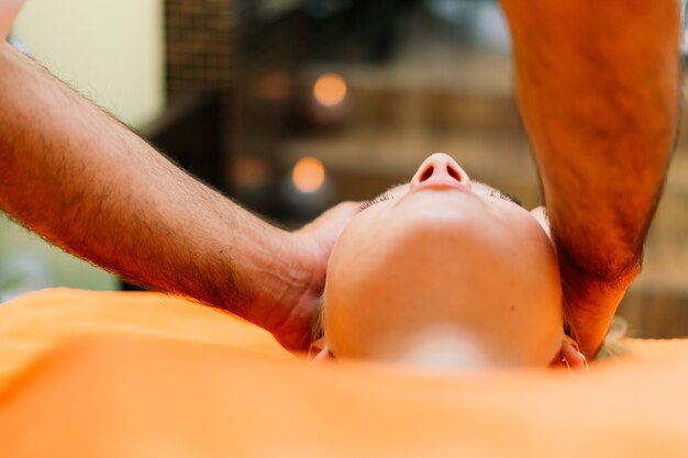 An attractive latin american woman lying down on a massage bed at a spa