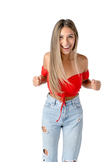 Attractive Latin woman with clenched fists and joyful expression celebrating an achievement on a pure white background.