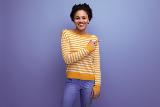 Attractive latin young woman with afro hair in a yellow striped blouse