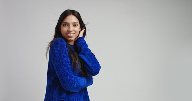 Attractive Latino female model in warm bright blue sweater