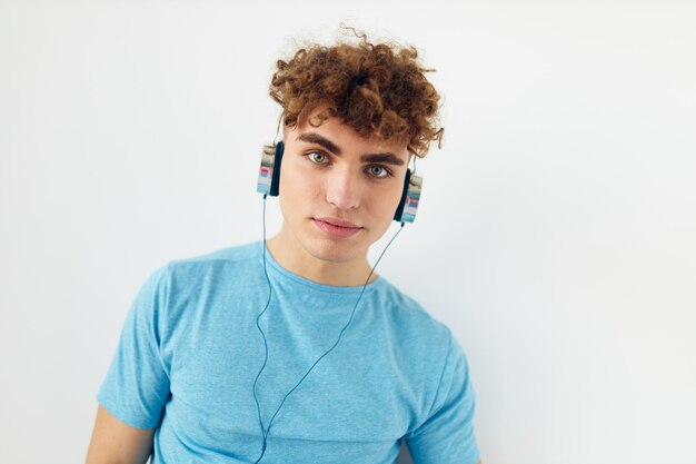 Attractive man in blue tshirts headphones fashion isolated background