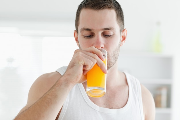 attractive man drinking orange juice