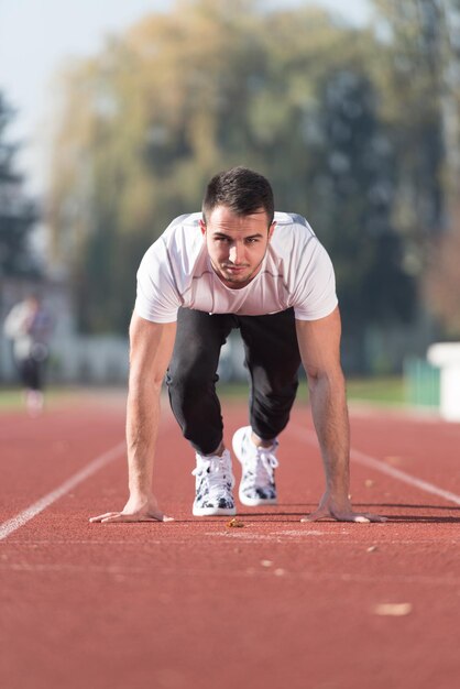 Attractive Man Getting Ready for the Race in City Park Area  Training and Exercising for Endurance  Fitness Healthy Lifestyle Concept Outdoor