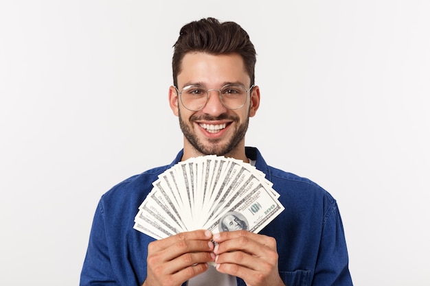 Attractive man is holding cash money in one hand, on 