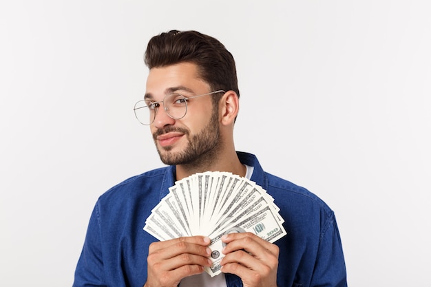 Attractive man is holding cash money in one hand, on 