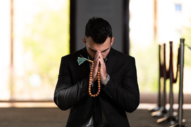 Attractive Man Making Traditional Prayer to God Allah in the Mosque