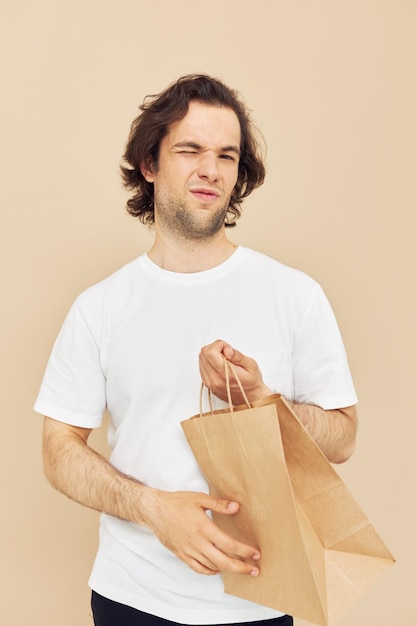 Attractive man paper grocery bag posing isolated background