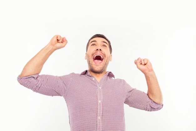 Attractive man screaming and showing fists