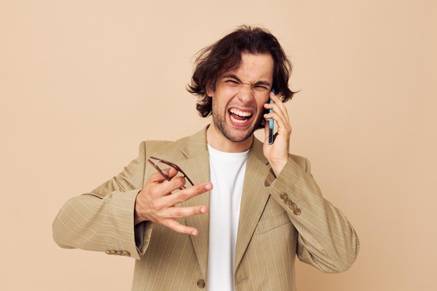 Attractive man in a suit posing emotions talking on the phone lifestyle unaltered