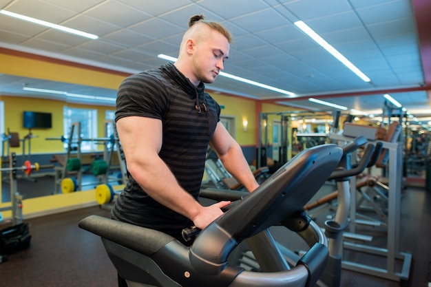 Attractive man on a treadmill at the gym