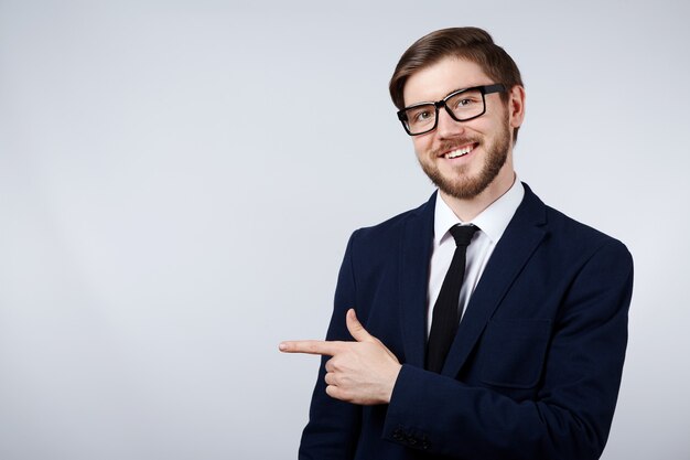 Attractive man wearing suit and glasses at studio