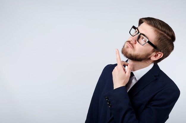 Attractive man wearing suit and glasses  wall thinking, business concept, copy space, portrait, mock up.