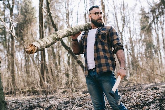 Attractive man with axe and log