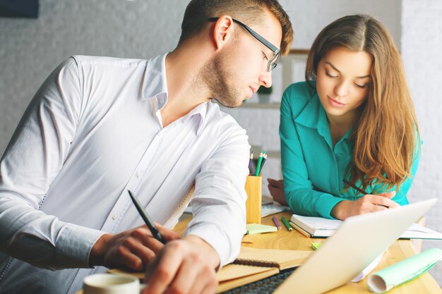 Attractive man and woman working on project